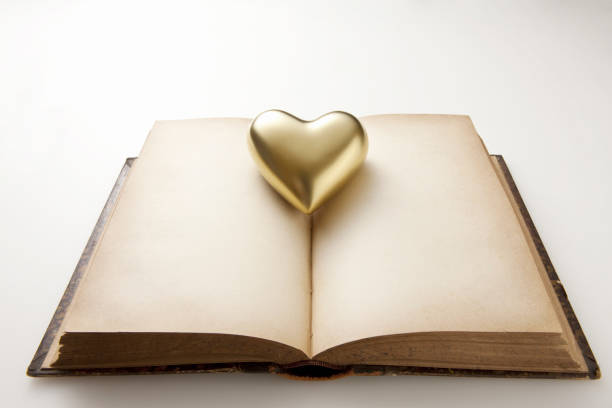 istock Gold heart and antique book 1324995417