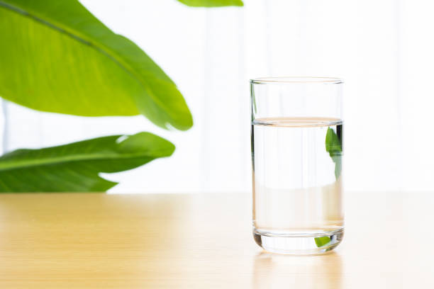 istock Drinking water in a glass on the table. 1324996399