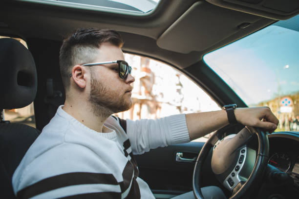 istock strong confident man in sunglasses driving the car 1324996791