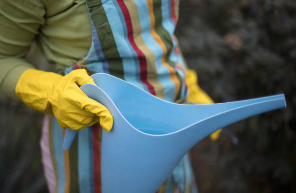istock Woman in garden holding can. 1324998825