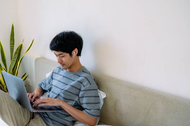 istock Freelancer man working in cozy bedroom. 1324998981