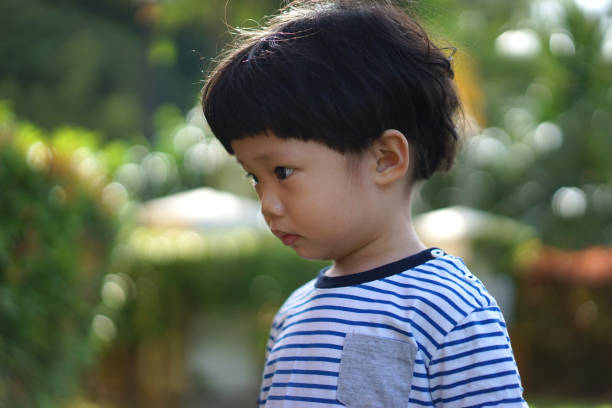 istock Side view of a little boy in the park 1325002335