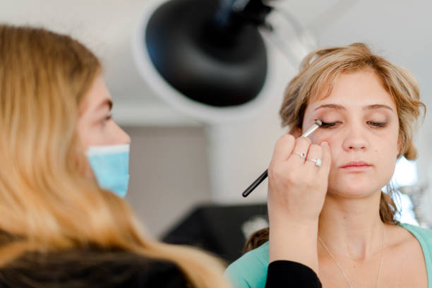 istock Over shoulder make up artist applying eyeshadow with small brush 1325002983