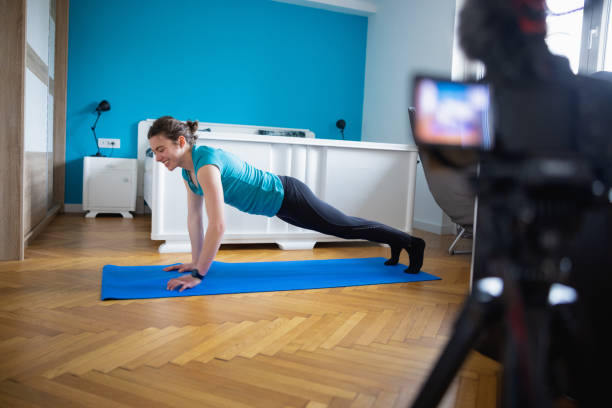 istock Smiling teenage girl making vlog on home exercise, doing push-ups 1325004701
