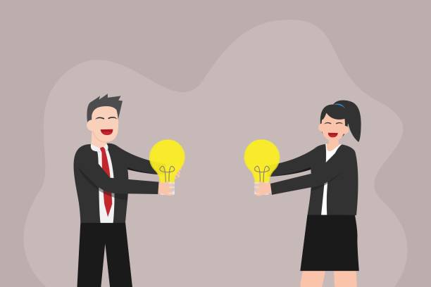 istock Businessman and businesswoman holding light bulb 1325009022