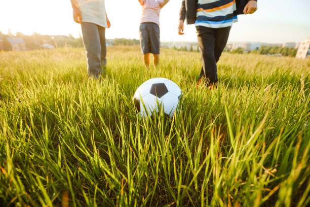 istock School-age boys play soccer during the summer holidays. 1325009461