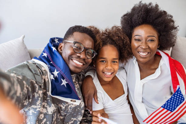 istock Soldier taking selfie with family. 1325009480
