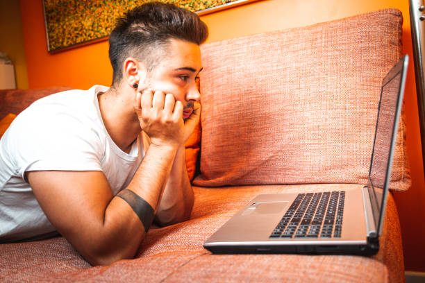 istock Young caucasian man using the laptop at the sofa 1325009536