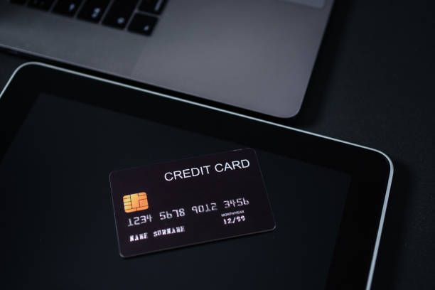 istock Black tinted image of credit card on digital tablet. 1325011484