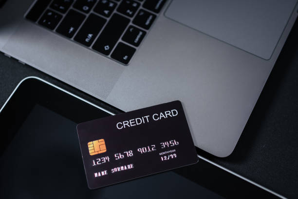 istock Black tinted image of credit card on digital tablet. 1325012045