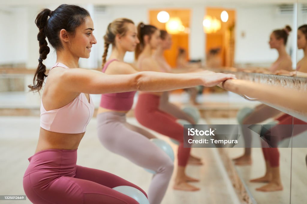 Barre fit exercise class. Group of people in a row at a barre workout class Yoga and Pilates
Barre fit Barre Stock Photo