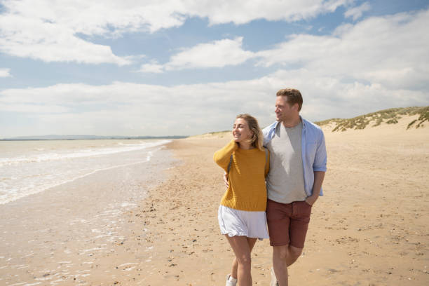 istock Couple enjoying springtime getaway at the beach 1325013917
