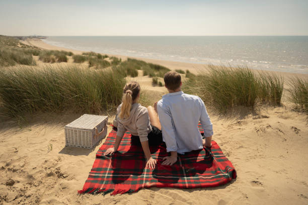istock Springtime vacationers enjoying day at the beach 1325013923