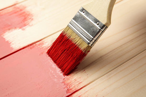 istock Painting wooden surface with red dye, closeup 1325013947