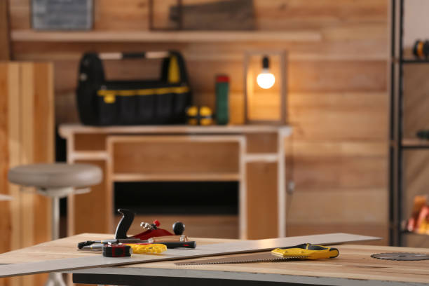 Different carpenter's tools on wooden table in workshop. Space for text Different carpenter's tools on wooden table in workshop. Space for text woodshop stock pictures, royalty-free photos & images