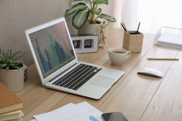 istock Stylish workplace with laptop on wooden desk. Interior design 1325014013
