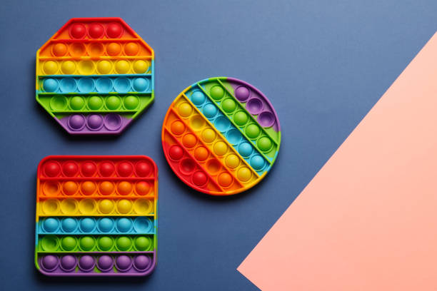 istock Rainbow pop it fidget toys on color background, flat lay. Space for text 1325014022