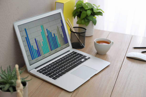 istock Stylish workplace with laptop on wooden desk. Interior design 1325014030