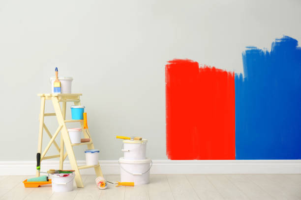 istock Decorator's kit of tools and paints near light wall indoors 1325014103