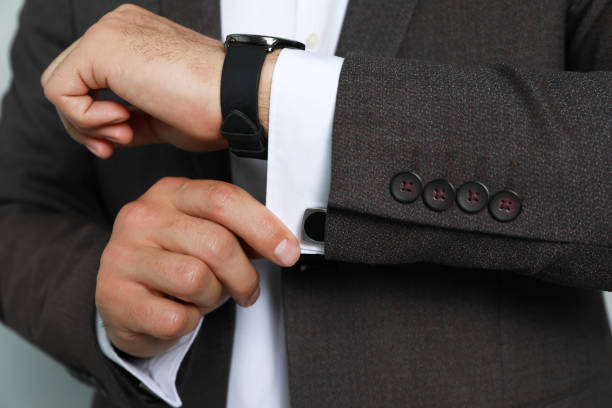 istock Stylish man putting on cufflink, closeup view 1325014615