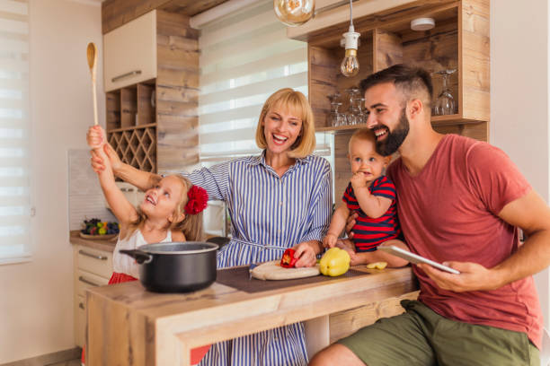 istock Parents having fun cooking dinner with their children 1325014697