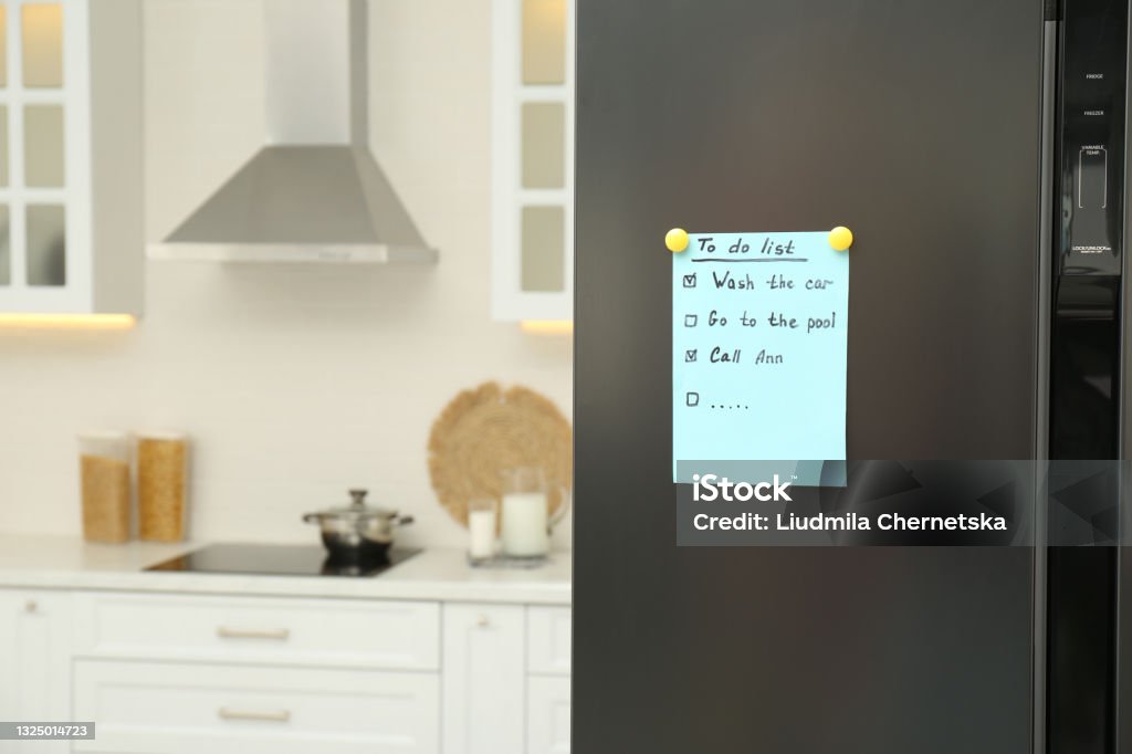 To do list on fridge in kitchen. Space for text Refrigerator Stock Photo