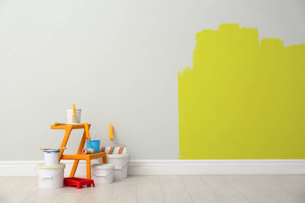 istock Decorator's kit of tools and paints near light wall indoors 1325014992