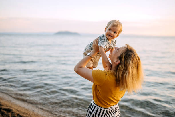 istock Mother and son playing on the beach 1325015048