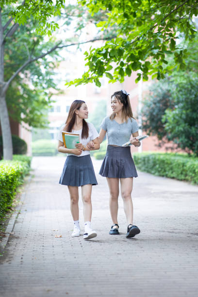 istock University student walking and talking in campus 1325015858