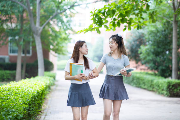 istock University student walking and talking in campus 1325015871