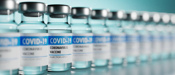 Row of Coronavirus vaccine flasks. Shallow depth of field. stock photo