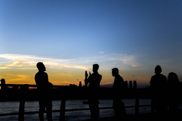 istock Young men taking photos of magnificent sunset view 1325018523