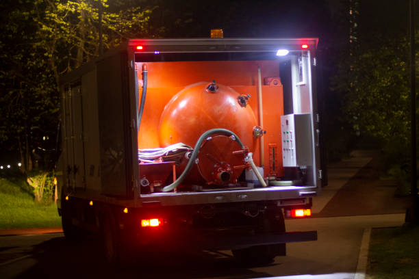 Outdoor toilet cleaning. Shit transporting machine. Taking shit out of the park at night.