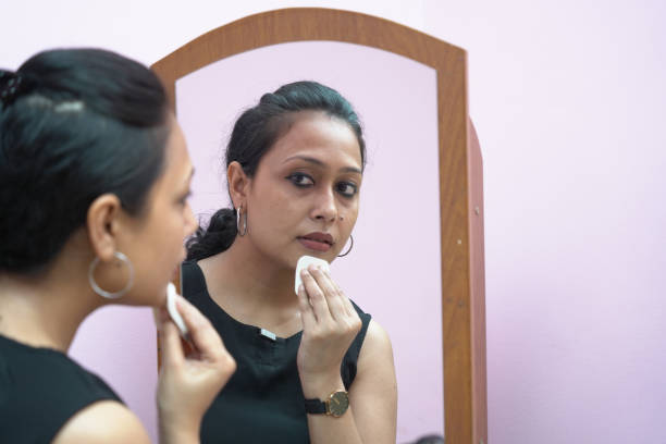 istock A lady in 30s putting make up in front of a mirror. 1325021253