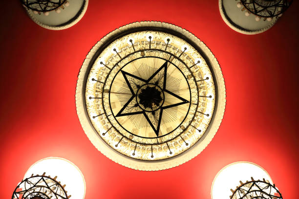Chandelier with sign of Soviet star on red ceiling