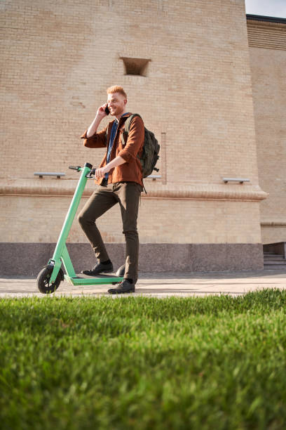 istock Man spending day outdoors and travelling on powered scooter 1325023604