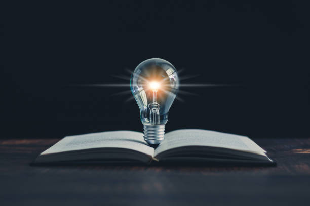 istock Glowing light bulb and book or text book with futuristic icon. Self learning or education knowledge and business studying concept. Idea of learning online class or e-learning at home. 1325023808