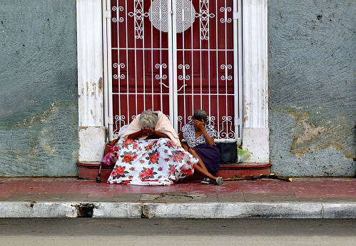Leon, Nicaragua, February 7th, 2012: Two Female Beggars Sitting on a Doorstep.