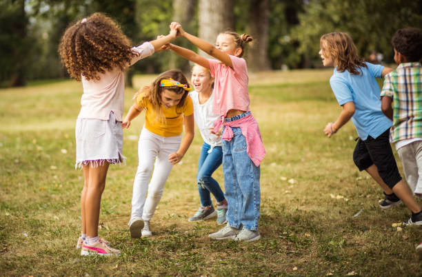 istock Large group of school kids having fun in nature.  Funny time for them. 1325024255