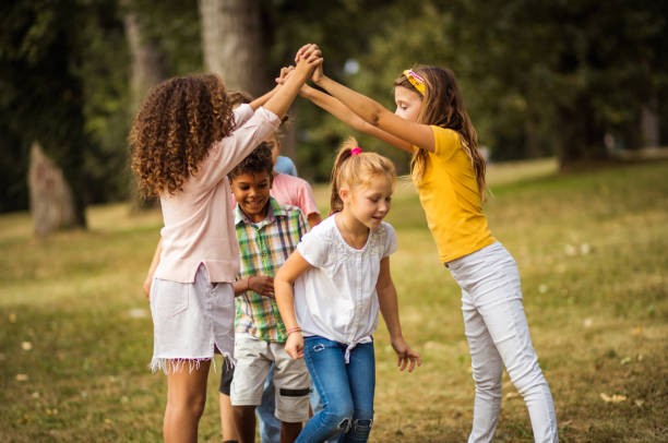 istock School friends playing in nature. 1325024267