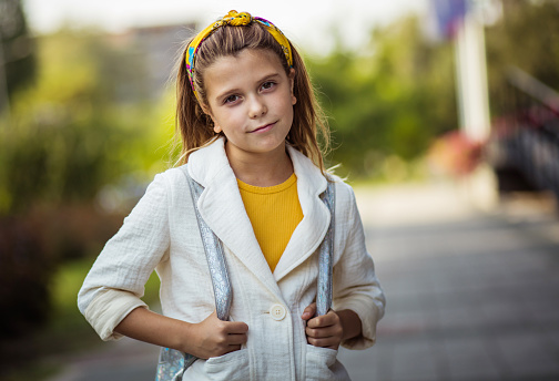 Portrait of school girl standing outside.