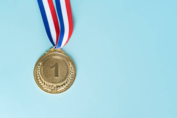 istock gold medal on blue background.award and victory concept.copy space 1325025702