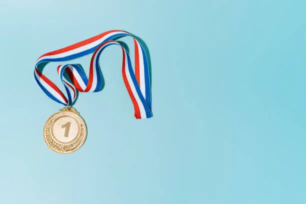 gold medal on blue background.award and victory concept.copy space