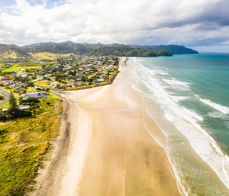 An aerial view looking along the idyllic Waihi Beach, located on the Coromandel Peninsula, on New Zealand's North Island.