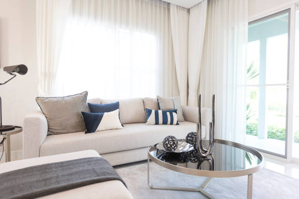 istock Contemporary living room interior with white settee and blue pillows on it. 1325029419