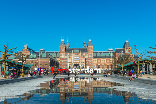 Amsterdam, the Netherlands - March 12, 2014: I amsterdam sign at Museumplein, Rijksmuseum in the back
