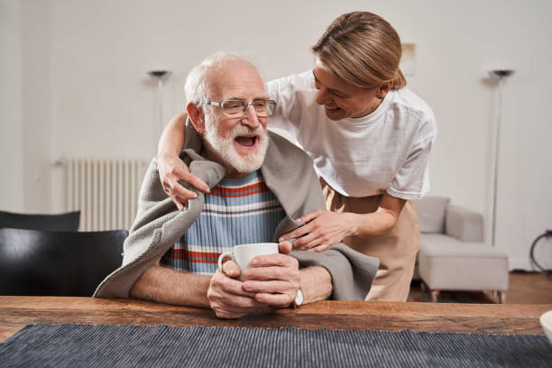 istock Murse warming up with blanket her senior patient while working 1325030062