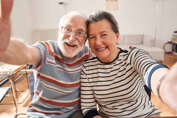 istock Senior people making selfie while sitting at the table at the retirement house 1325030079