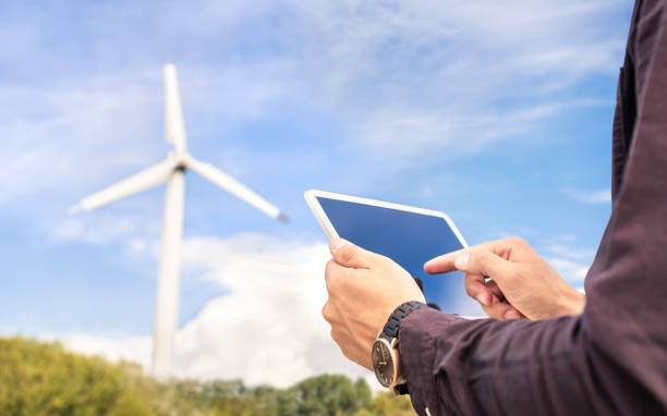 istock Wind power and sustainable energy field worker with tablet. Engineer or technician in green renewable electricity generation industry. 1325031184