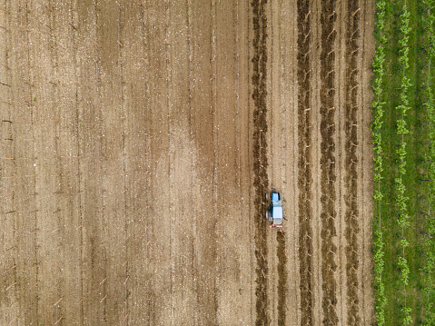 Directly Above a Tractor Working on Vineyard.